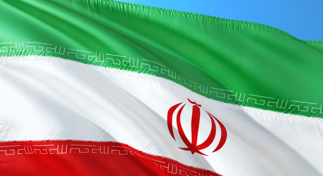 Persian flag waving in a blue sky