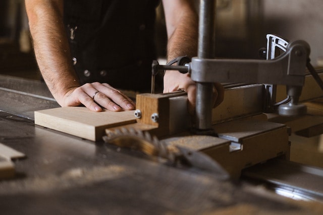 a guy working with a woodworking machine